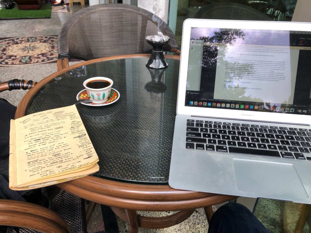 Justin's laptop and his yellow notebook.